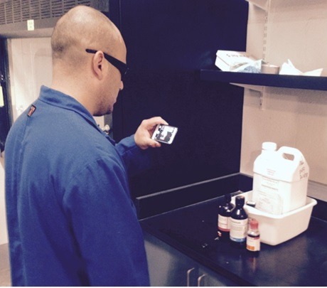 labs person taking photo of haz waste